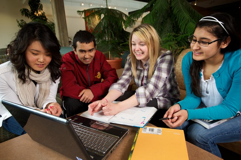 Students studying in HUB- Endowment report photograph Doors on campus- Campus Scenes